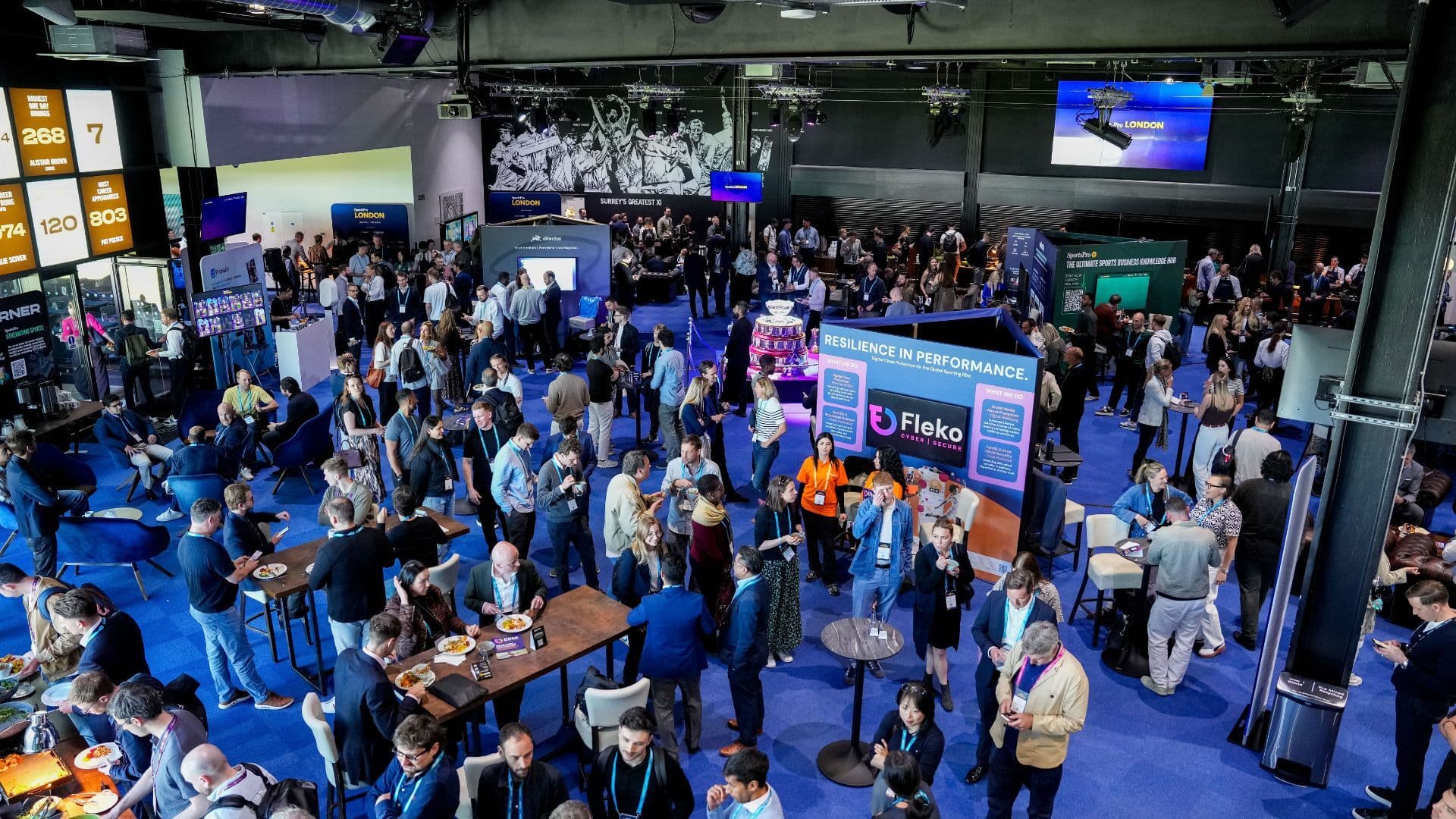 Overhead view of attendees networking among exhibition stands at a SportsPro event.