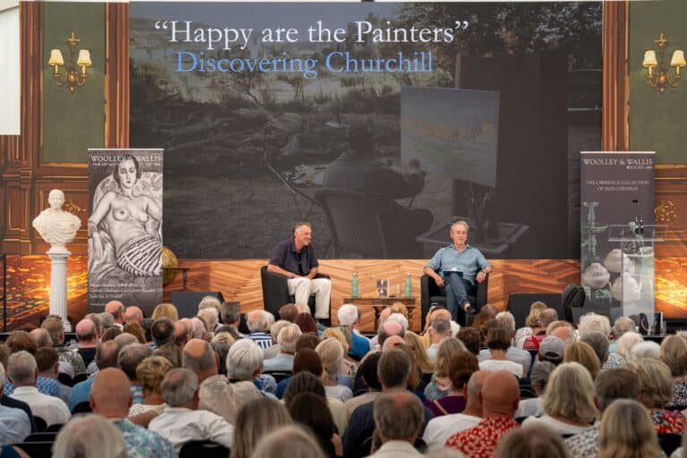 Two speakers on stage beneath a large presentation screen at Chalke History Festival 2026