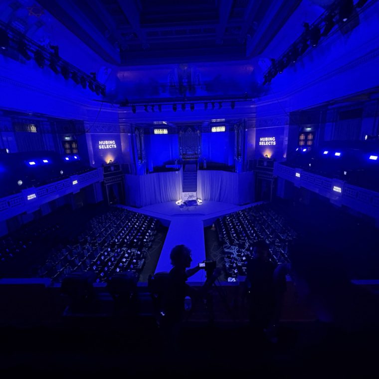 Blue-lit venue with a central runway and audience seating for eBay Live's Endless Runway at London Fashion Week 2026