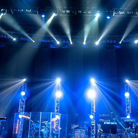 lighting equipment at concert - colored spotlights on ceiling in smoke, leaving room for showcased content.